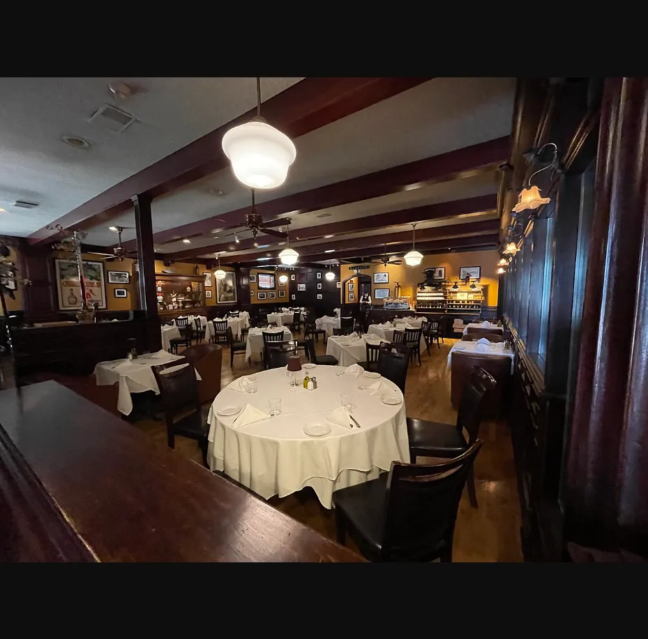 Upscale Italian restaurant dining room with white tablecloths